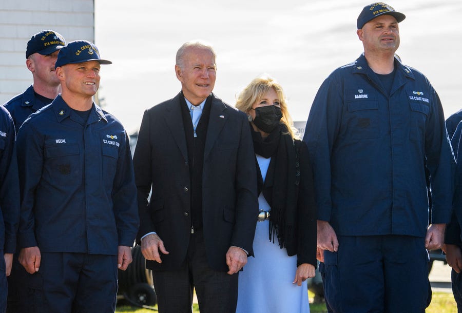 President Joe Biden and first lady Jill Biden pose for a photo with members of the Coast Guard at the US Coast Guard Station Brant Point in Nantucket, Massachusetts, on Thursday, Nov. 25, 2021. The Bidens spent the Thanksgiving holiday in Nantucket.