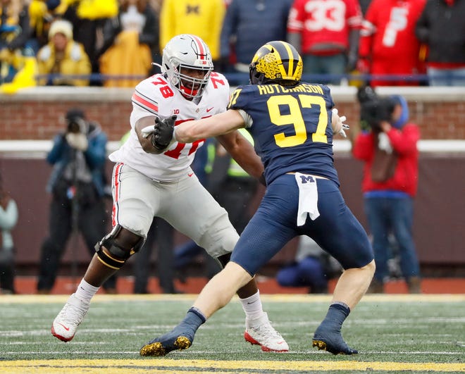 Ohio State Buckeyes offensive tackle Nicholas Petit-Frere (78) tries to block Michigan Wolverines defensive end Aidan Hutchinson (97) during the third quarter in a NCAA College football game at Michigan Stadium at Ann Arbor, Mi on November 27, 2021.