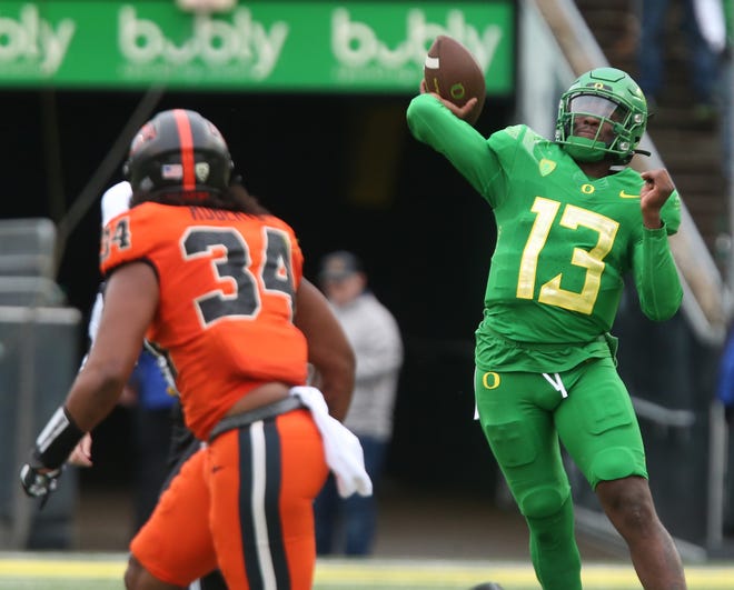 Oregon's Anthony Brown throws for a 50-yard  touchdown against Oregon State during the first quarter of Saturday's game.