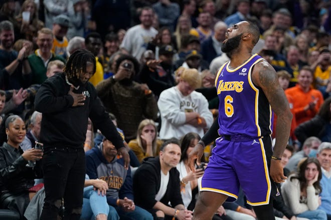 Los Angeles Lakers' LeBron James reacts after hitting a shot during overtime of in the team's NBA basketball game against the Indiana Pacers, Wednesday, Nov. 24, 2021, in Indianapolis.