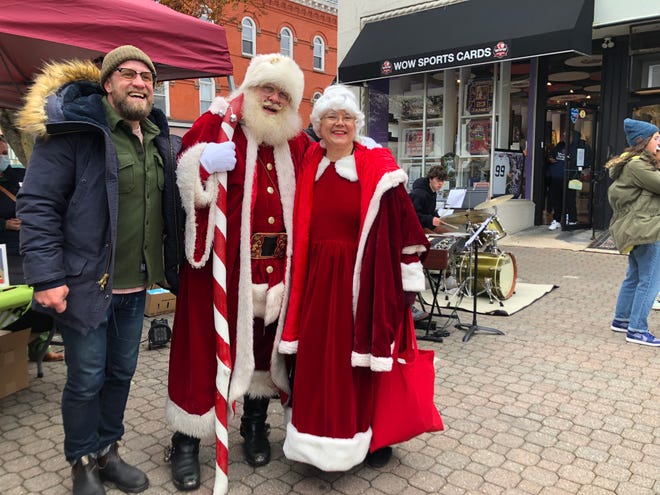 Jason Gleason, executive director of the Montclair Business Improvement District, with Santa and Mrs. Klaus on Small Business Saturday.