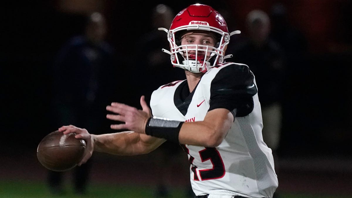 Brophy's Elijah Warner (13) looks to throw against Red Mountain during their 6A playoff game in Mesa Nov, 26, 2021.       