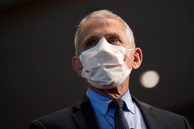 Dr. Anthony Fauci, director of the National Institute of Allergy and Infectious Diseases, speaks with Health and Human Services Secretary Alex Azar before receiving his first dose of the COVID-19 vaccine at the National Institutes of Health on Dec. 22, 2020 in Bethesda, Maryland. (Patrick Semansky/Pool/Getty Images/TNS)
