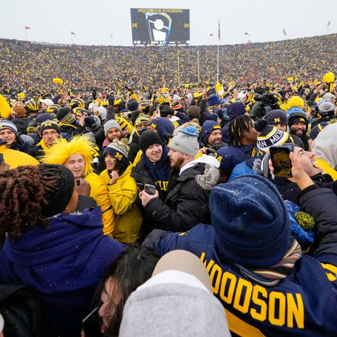 Wolverines fans rush the field to celebrate the 42