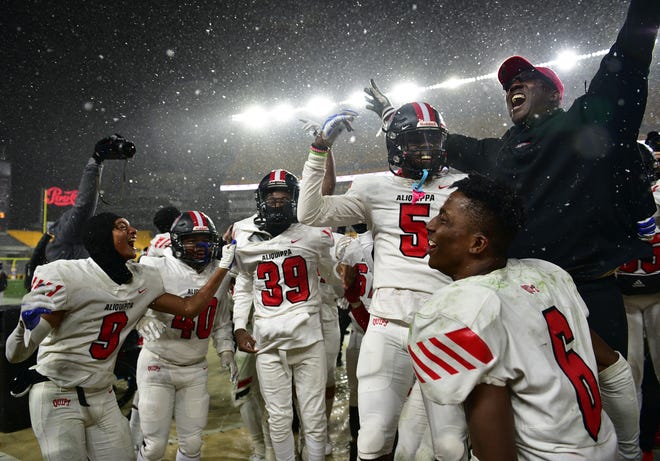 Aliquippa players celebrate with head coach Mike Warfield after they beat Belle Vernon 28-13 in the WPIAL 4A Championship on Saturday, Nov. 27, 2021, at Heinz Field.