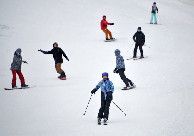 Skiers and boarders take a spin down Ralph's Run on Sunday at Wachusett Mountain ski area in Princeton.