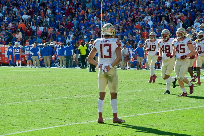 Jordan Travis looks at his team during the FSU-UF rivalry game.