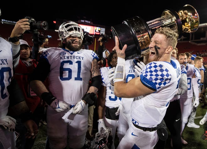 Kentucky quarterback Will Levis celebrates with the Governor's Cup after defeating Louisville 52-21. Nov 27, 2021