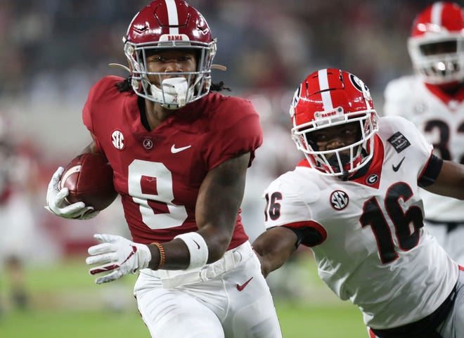 Alabama wide receiver John Metchie III (8) catches a touchdown pass behind Georgia defensive back Lewis Cine (16) during Alabama's 41-24 win over Georgia in Bryant-Denny Stadium Saturday, Oct. 17, 2020. [Staff Photo/Gary Cosby Jr.]