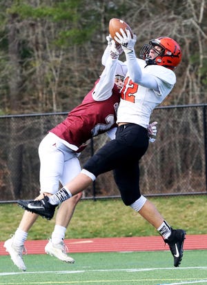 Middleboro's Cam Downey makes the catch over Carver defender in the endzone during the annual Middleboro vs. Carver Thanksgiving Day football rivalry last Thursday at Carver High School. Middleboro won the game, 40-11. See more in SPORTS. 