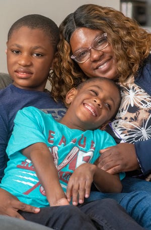 Natasha Iso of Covington with her sons Nayshawn, 11, and Markus, 6. She is looking for a washer and dryer since she does laundry for her family and her sister and her sister's family of five children.  Markus has a chronic lung disease and learning disability. Natasha is currently enrolled in the Cincinnati COOKS program and would like to become a chef.