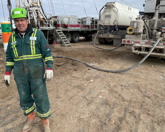 Curt Shuck of the Well Done Foundation poses near a oil well capping project in Toole County, Mont., on Nov. 18, 2021. Shuck started the Well Done Foundation to raise money and cap abandoned oil wells to prevent them from continuing to release methane gas into the atmosphere. Methane is a greenhouse gas because it traps heat in the atmosphere, according to the EPA. (Phil Drake/Independent Record via AP)