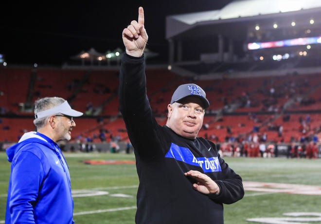 Kentucky's Mark Stoops acknowledges the crowd yelling "Stoops" after he helped coach  the Wildcats defeat Louisville 52-21 Saturday night. Nov. 27, 2021 