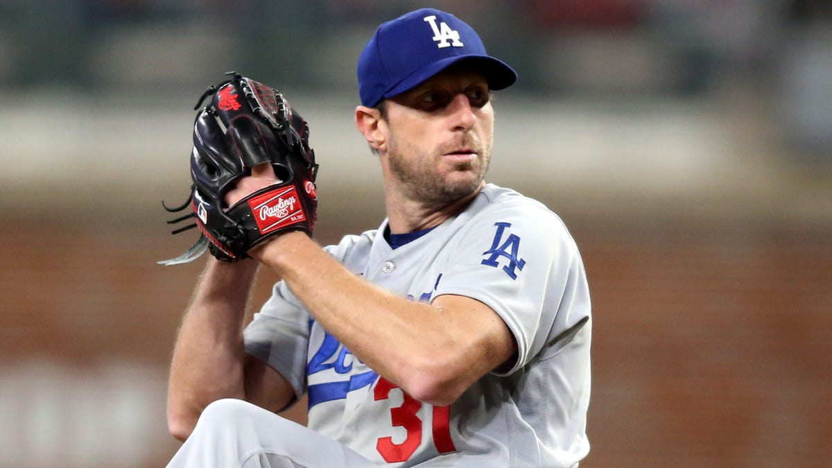 Los Angeles Dodgers right-hander Max Scherzer (31) pitches against the Atlanta Braves during the first inning in Game 2 of the 2021 NLCS at Truist Park.