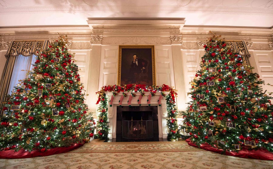 Christmas trees are seen in the State Dining room decorated to celebrate the 'Gift of Family.'