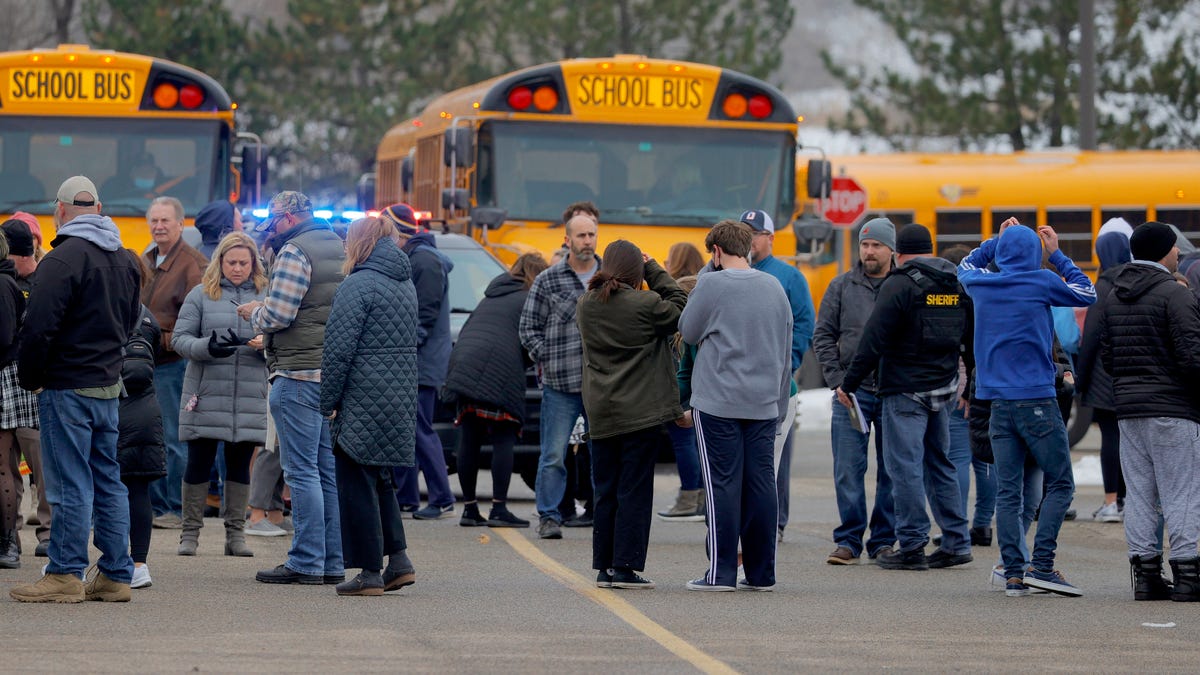 Parents wait to be reunited with their kids following an active shooter situation at Oxford High School in Oxford on November 30, 2021. Police took a suspected shooter into custody and there were multiple victims, between four and six, the Oakland County Sheriff's office said.