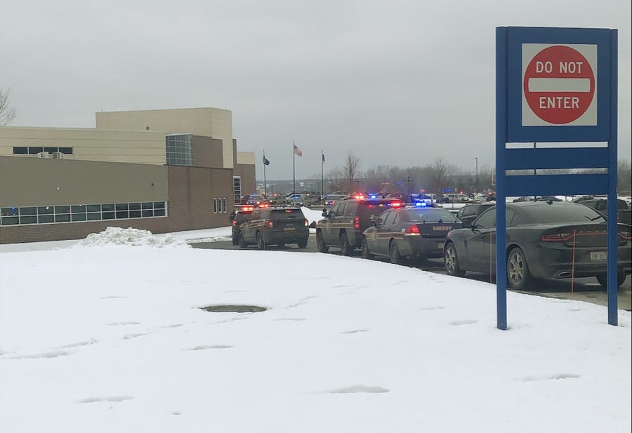 Police cars line up after an active shooter situation at Oxford High School in Michigan on Nov. 30. Police had a suspect in custody.
