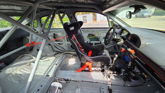 The interior of the 2022 Honda Civic Si TCA race car strips out everything but the dash - which race designers were determined to keep for its signature value.