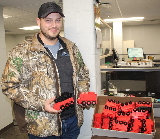 Tyler Flaagan, assistant professor of computer and cyber sciences at DSU, used his two 3D printers to make 23 toy train engines to give to the nearest Toys for Tots shipping hub at the end of November.