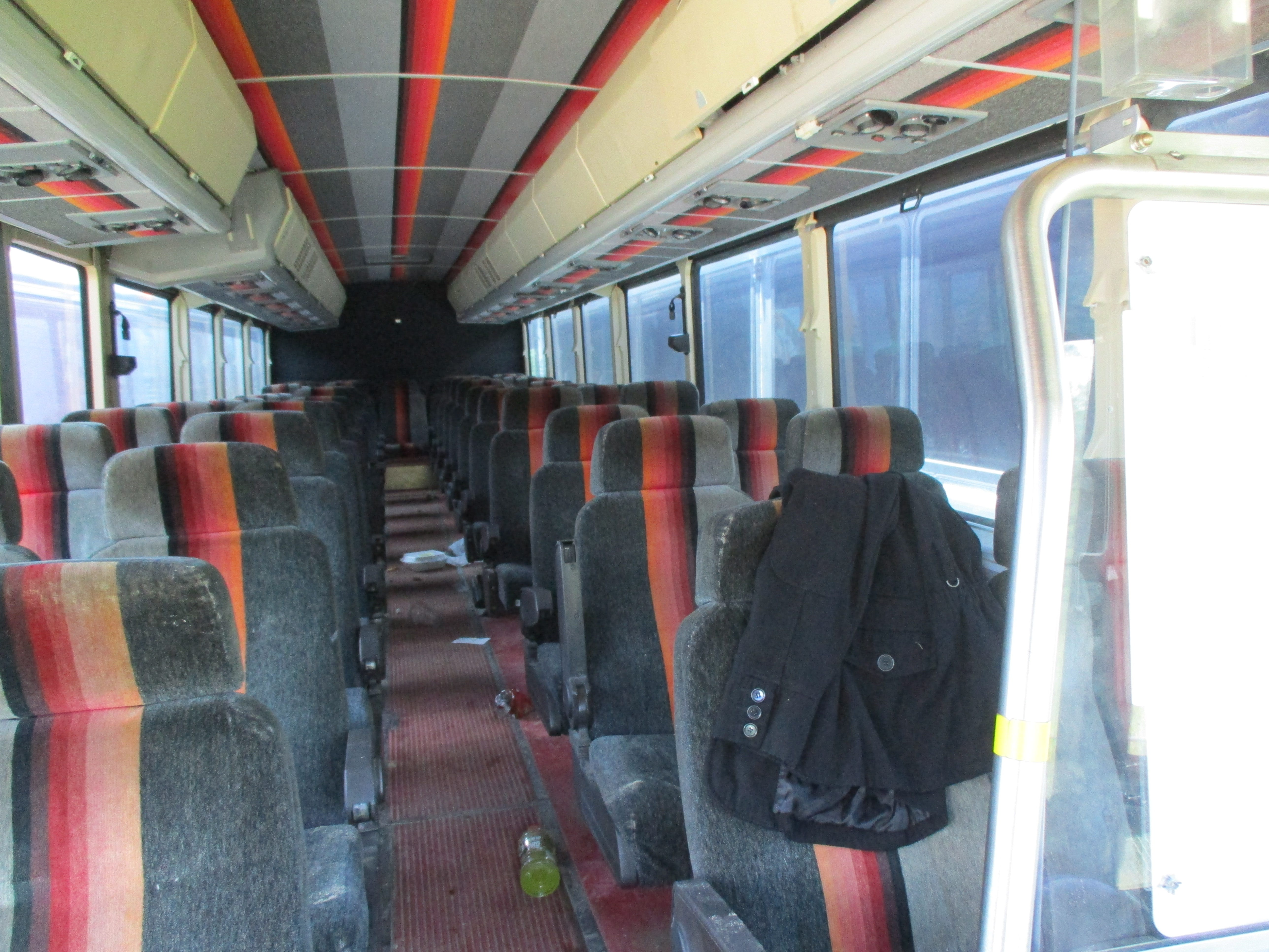 The inside of a bus used to transport workers to the job site. 