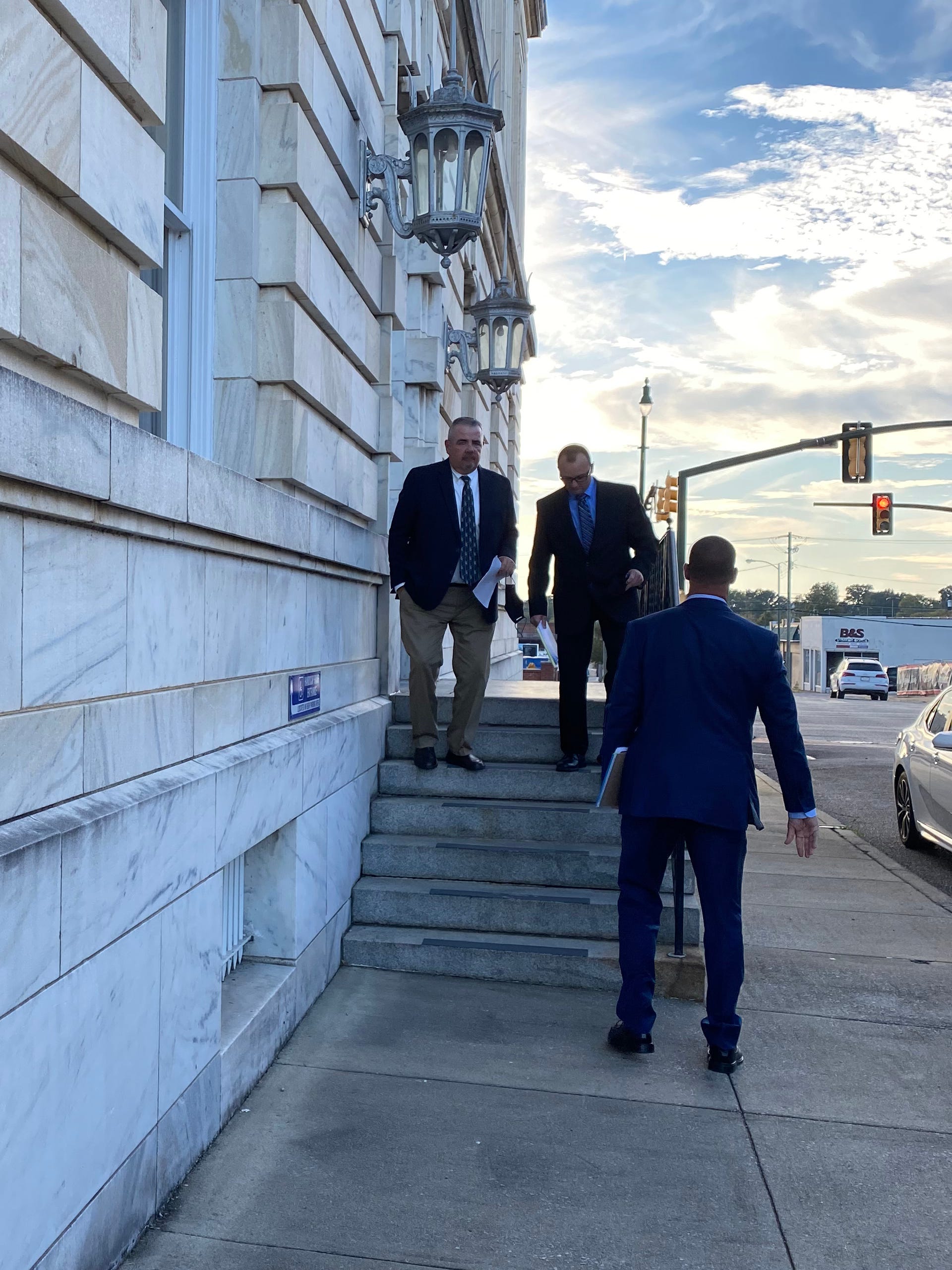 George Morris, left, a retired Rainbow City police officer, leaves the federal courthouse in Anniston, Ala., with two former colleagues. Tiara Helm sued Morris for shocking her with a Taser after she was having seizures in 2015.