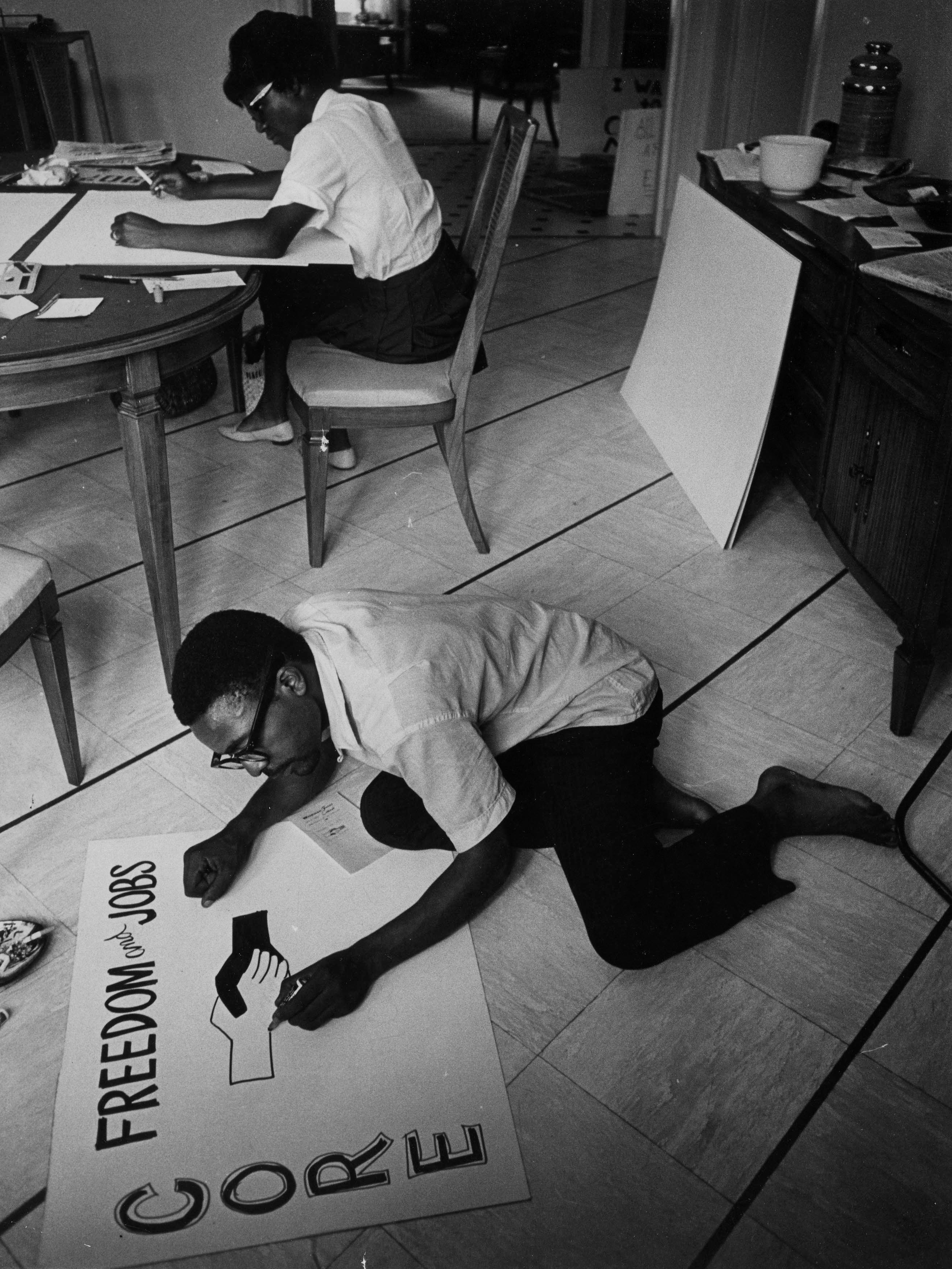 Ronnie Moore, foreground, joins another Congress of Racial Equality (CORE) worker making signs.