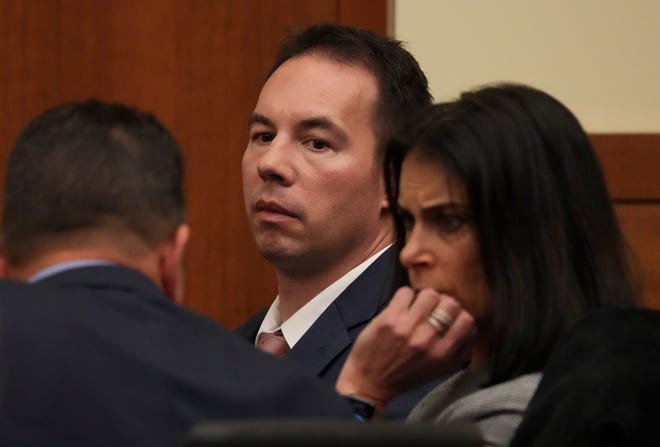 William Husel, center, listens as his attorneys, Jose Baez, left, and Diane Menashe, right, confer Wednesday in a Franklin County courtroom during a hearing on their motion to dismiss the 25 murder counts against the former Mount Carmel Health intensive-care physician, who is accused of purposely killing intensive-care patients with pain-killer overdoses. Franklin County Common Pleas Judge Michael J. Holbrook denied the motion Friday.