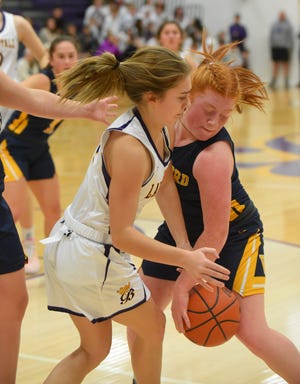 Whiteford's Ava Hillard defends June Miller of Blissfield Tuesday night. The Royals won 51-35.
