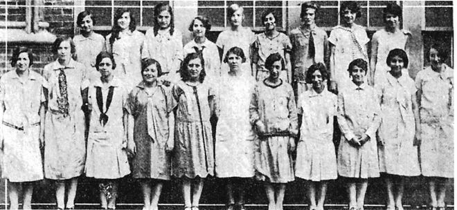 Young women attending Roscoe Conkling Elementary School, on Mohawk Street in East Utica, in the late 1920s and early 1930s, were taught how to make their own dresses in classes taught by Anna Graham and supervised by Lena Munger. Displaying their dresses is this class, back row left to right: Teresa Costello, Mamie Cutrie, Deicia Stuber, Millie Arcone, Mae Gilliland, Rose Dannes, Alice Durr, Mary Ciccone and Marie Grieco. Front row left to right: Julia Colacicco, Lena Decker, Carolyn San Andres, Rose Perretta, Madeline Conti, Anna Graham (teacher), Teresa Malara, Carolyn DiOrio, Anna Stocco, Cecelia Peters and Eleanor McCulloch.