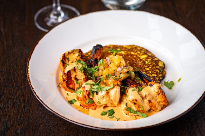 On the menu at Corvina: Grilled prawns “Diablo” served in a chipotle cream sauce with a Venezuelan sweet corn and cheese cachapa (pancake) and pineapple chutney.