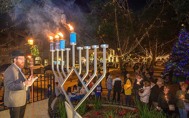 Rabbi Levi Vogel, director of Chabad of St. Augustine, talks to a crowd gathered on the Plaza de la Constitución for the 15th annual lighting of the city’s menorah in celebration of the third night of Hanukkah on Tuesday, Nov. 30, 2021.