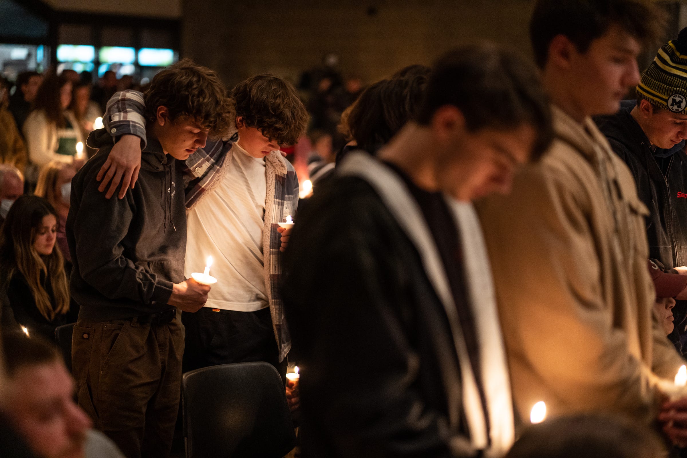 Oxford High School students who were present during the school shooting stand during a prayer vigil at LakePoint Community Church in Oxford following an active shooter situation at Oxford High School in Oxford on November 30, 2021. Police took a suspected shooter into custody and there were multiple victims, the Oakland County Sheriff's office said.
