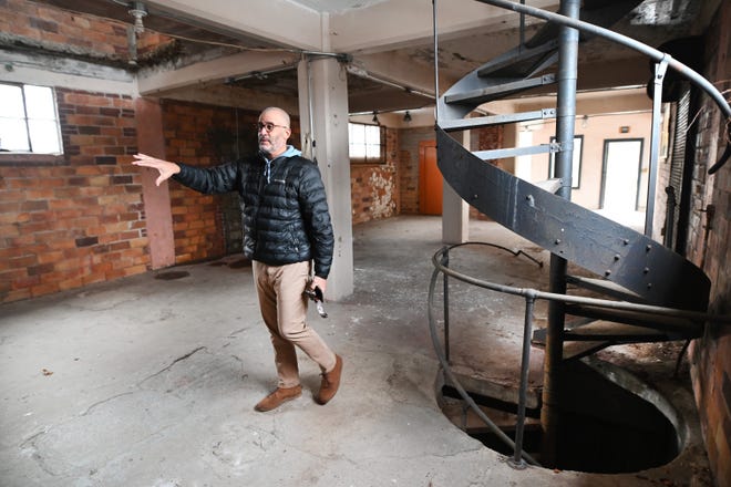 Jeff Guyton, who received a recreational marijuana dispensary license through the Michigan Marijuana Regulatory Agency's social equity program, tours a soon-to-be renovated Ypsilanti landmark, the 99-year-old former Farm Bureau building on Dec. 1. Guyton plans to open a Quality Roots dispensary in the summer 2022.