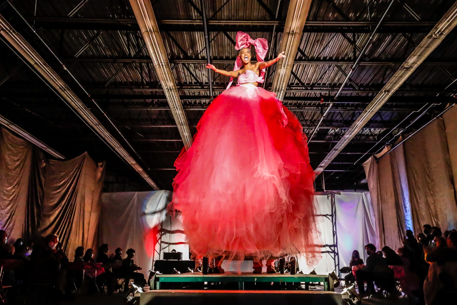 Event emcee Morgan Robinson-Gay rolls down the catwalk during the annual Herron Wearable Art Show on Thursday, Oct. 28, 2021, at the IUPUI Herron School of Art and Design Sculpture and ceramics building in Indianapolis.