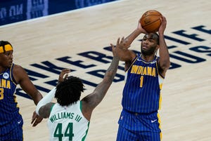 Indiana Pacers' T.J. Warren (1) shoots over Boston Celtics' Robert Williams III (44) during the second half of an NBA basketball game, Sunday, Dec. 27, 2020, in Indianapolis. (AP Photo/Darron Cummings)