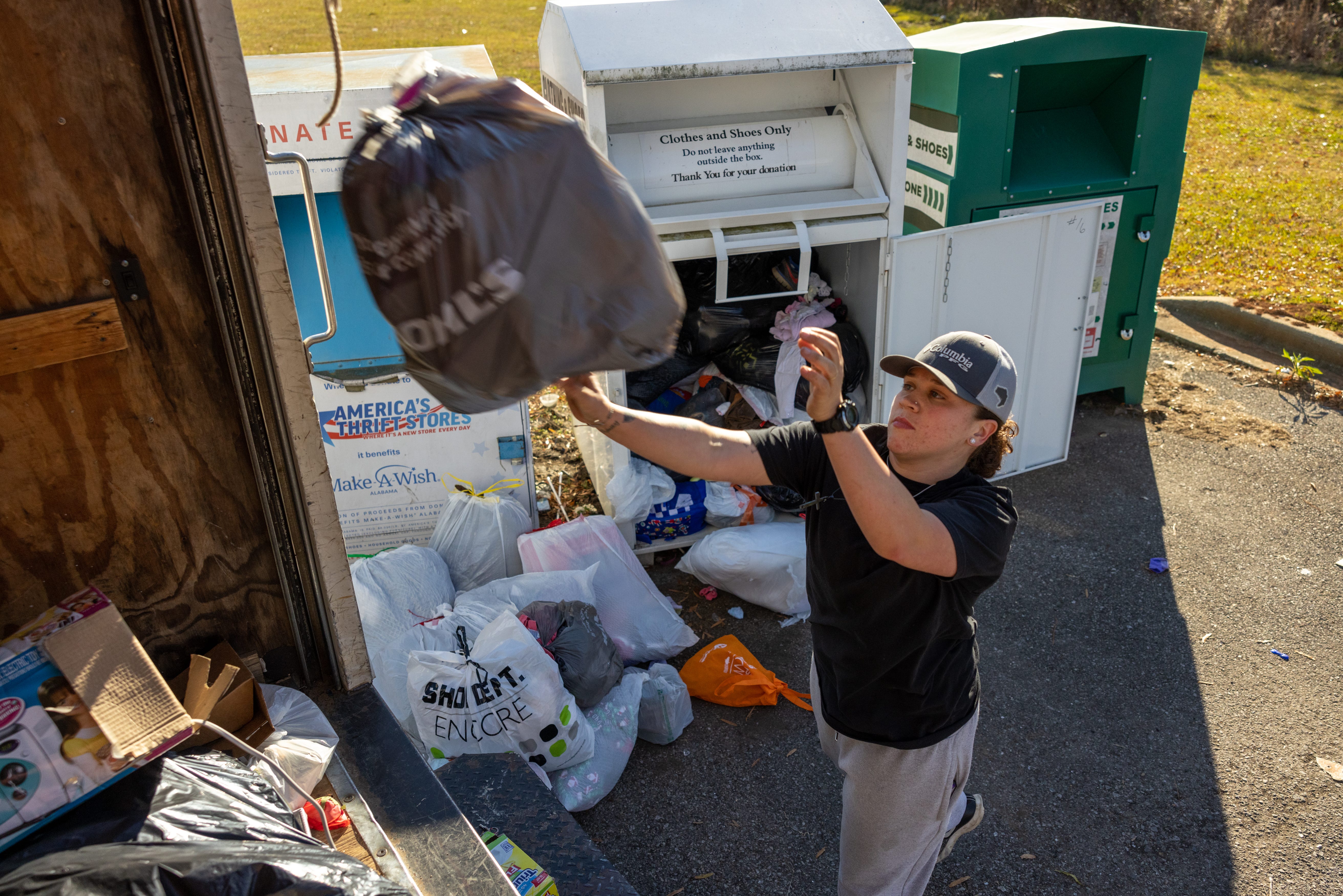 Tiara Helm loads donations into a truck as part of her job at a thrift store in Anniston, Ala.