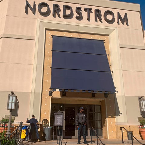 A security guard stands outside the Nordstrom stor