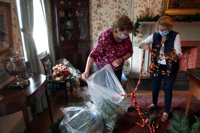 Linda Cottrill (left), Daughters of the American Revolution Worthington Chapter regent, and Jean Bermingham, also with DAR, sort through decorations to hang in preparation for the holiday events held at Worthington's Orange Johnson House on Dec. 2.