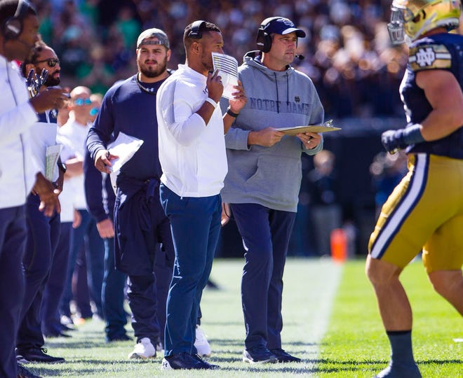 Notre Dame defensive coordinator Marcus Freeman and defensive line coach Mike Elston during the Notre Dame vs. Wisconsin NCAA football game Saturday, Sept. 25, 2021 at Soldier Field in Chicago. 