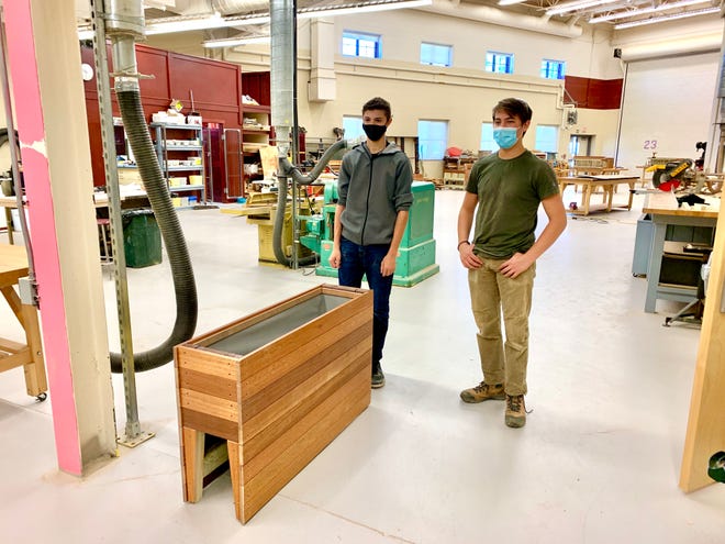 Portsmouth High School CTE students building planter boxes.