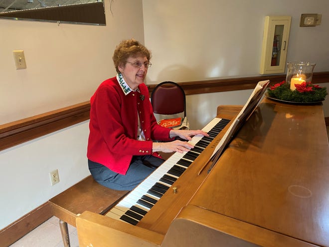 Kathy Sloan plays the piano during the Christmas walk-thru event at the Alliance Area Senior Center on Thursday, December 2, 2021.