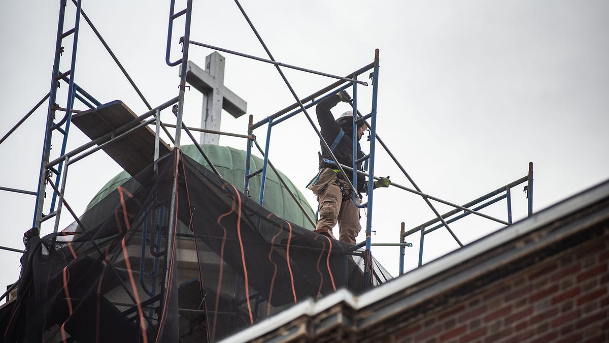 A construction worker dismantles the scaffolding around the tower at St. George's Episcopal Church in Newburgh, NY on Tuesday, November 30, 2021. The church is undergoing a large restoration on the tower and roof, the scaffolding around the tower is being dismantled.