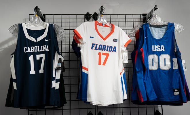 Michaelyn Roberson, president and founder of Empire Sports, sells collegiate and professional sports apparel in her Oak Park shop on Nov. 22, 2021.