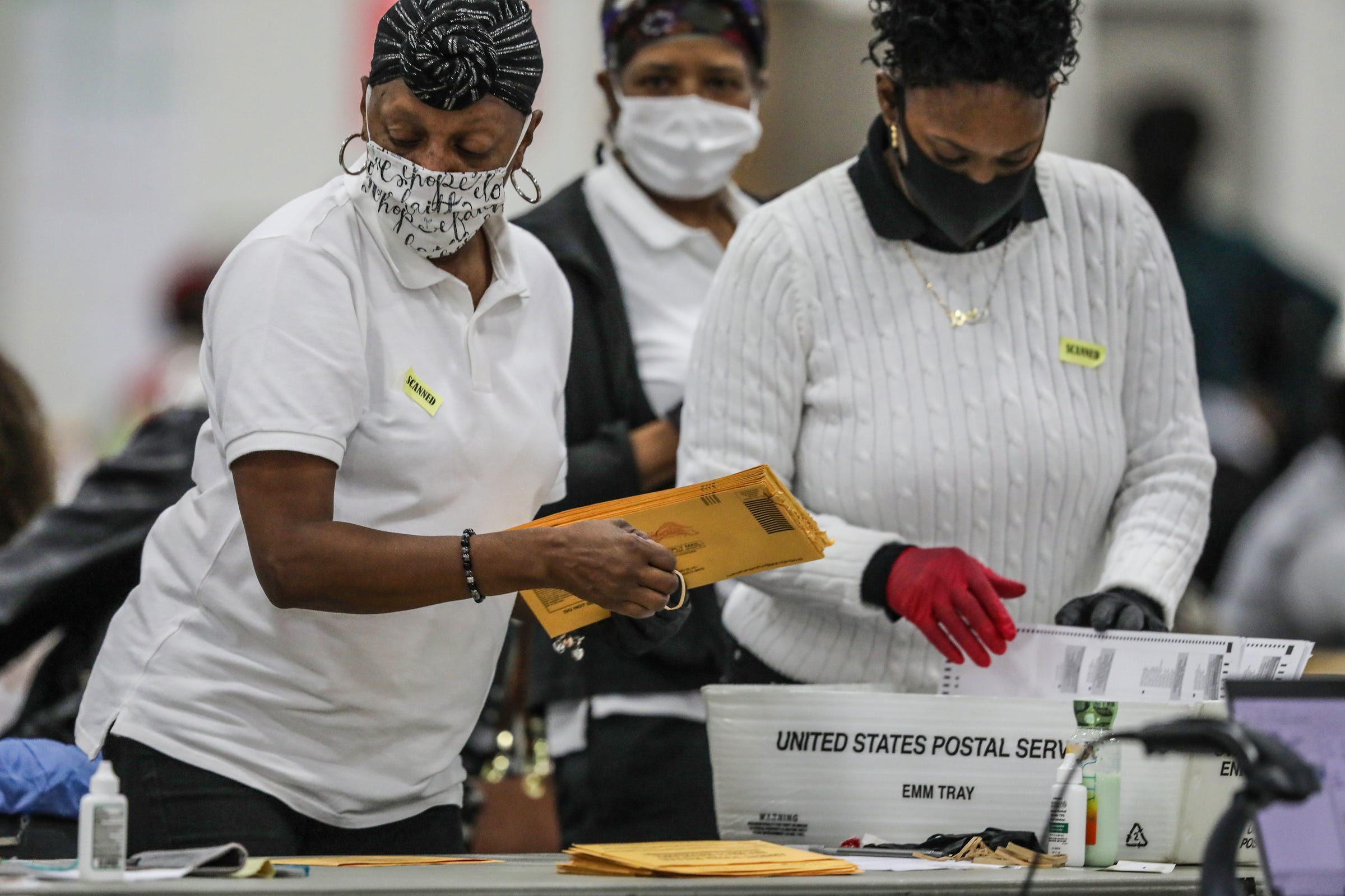 Election officials process absentee ballots at Detroit's TCF Center in November 2020.