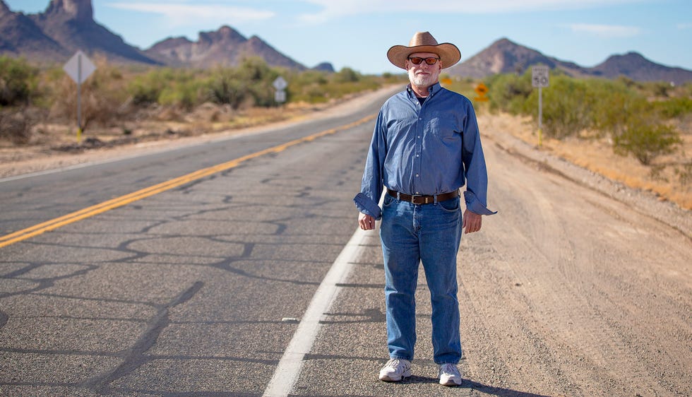Rob Behr stands for a photo on an isolated road near Tonopah landmark, Saddle Mountain, on Nov. 30, 2021.
