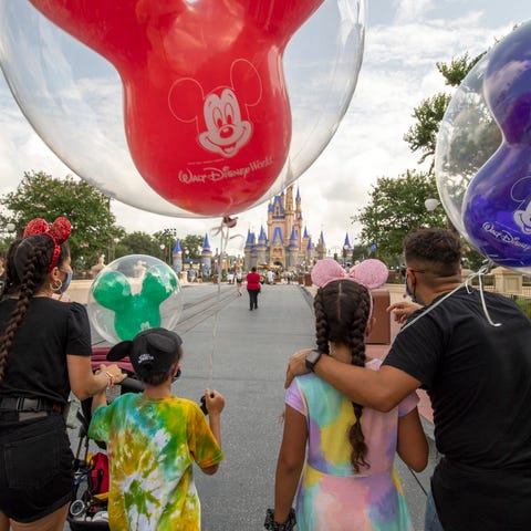 Guests walk down Main Street, U.S.A. at Disney Wor