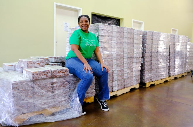 Laurel Mauldin, A Table in the Wilderness chief executive officer and president, sits on a pallet of food that Feed The Children gave to ministry for its plant-based food pantry.