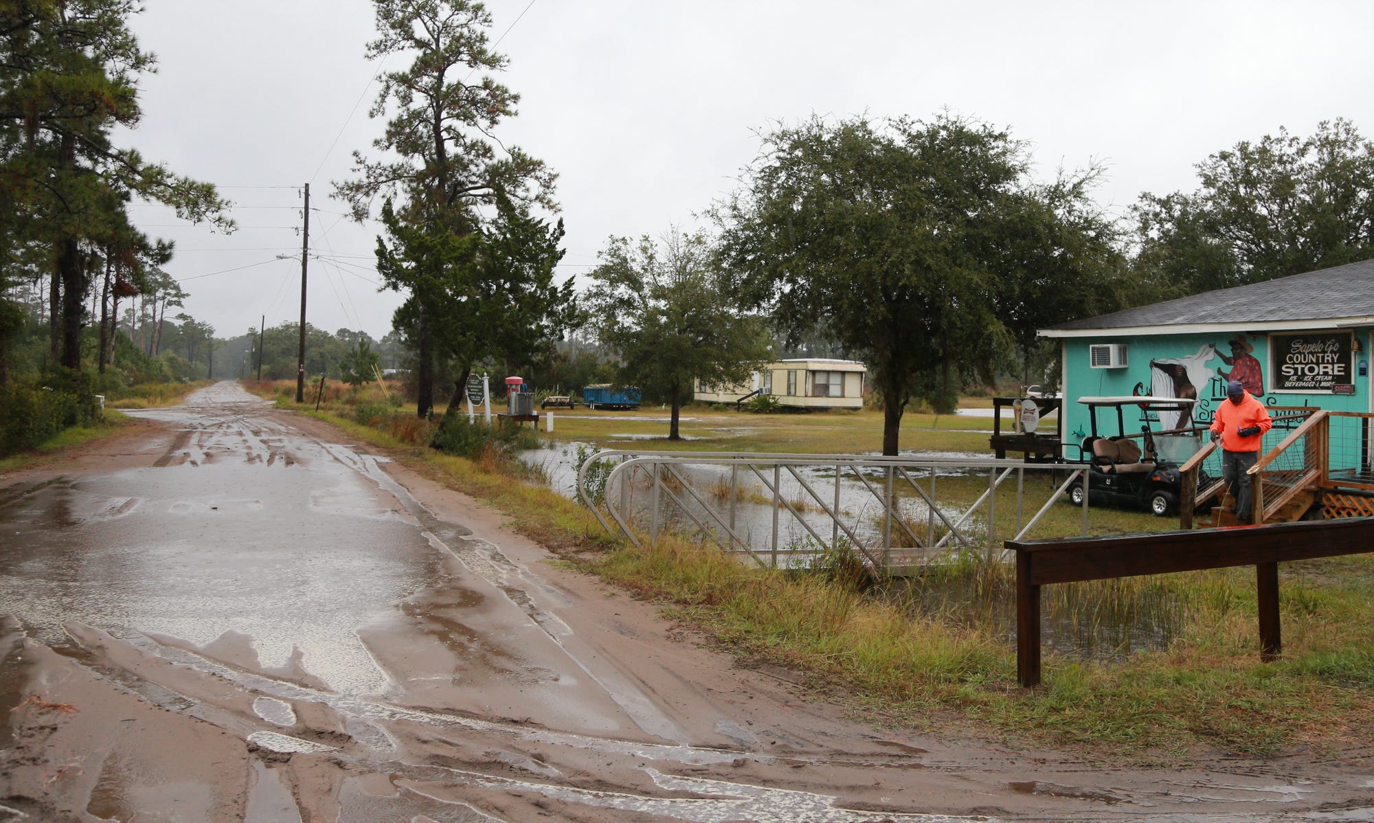 The water level rises out of the drainage ditch in front of Maurice Bailey's Sapelo Island store caused by a combination of rain and salt water being pushed inland from the King tides.