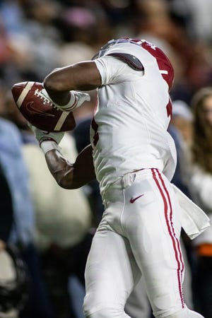Alabama wide receiver Ja'Corey Brooks (7) makes the game-saving touchdown reception on the final drive of regulation against Auburn during the second half of an NCAA college football game, Saturday, Nov. 27, 2021, in Auburn, Ala. (AP Photo/Vasha Hunt)