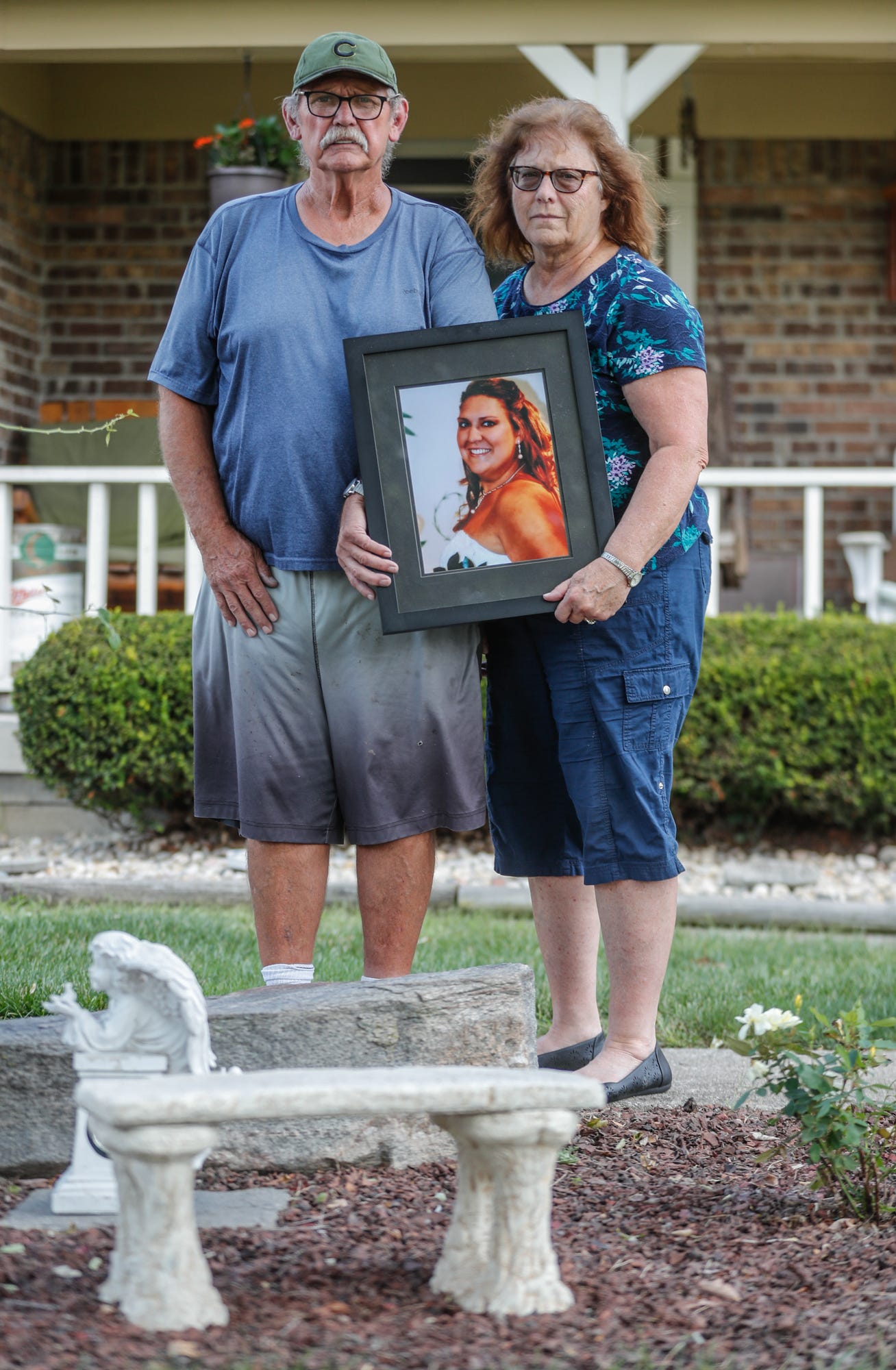 Thomas and Brenda Limbach hold a photo of their late daughter, Jill Phipps, on Tuesday, Sept. 14, 2021. The photograph of Phipps was taken on her wedding day. According to police, Phipps was shot and killed by her husband.